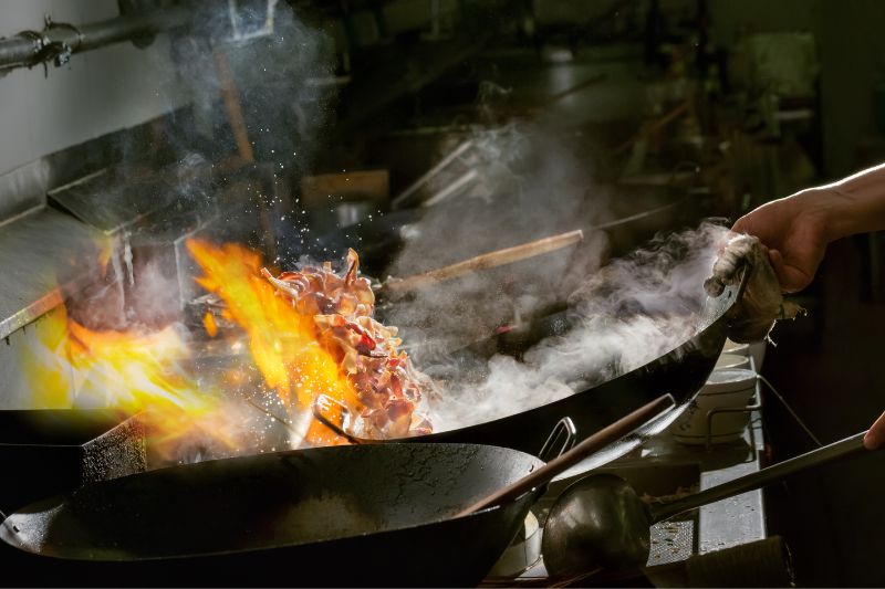 chinese chef cooking in a wok