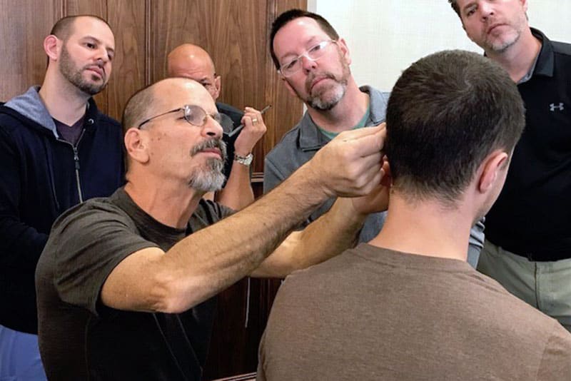 instructor demonstrating ear point acupuncture